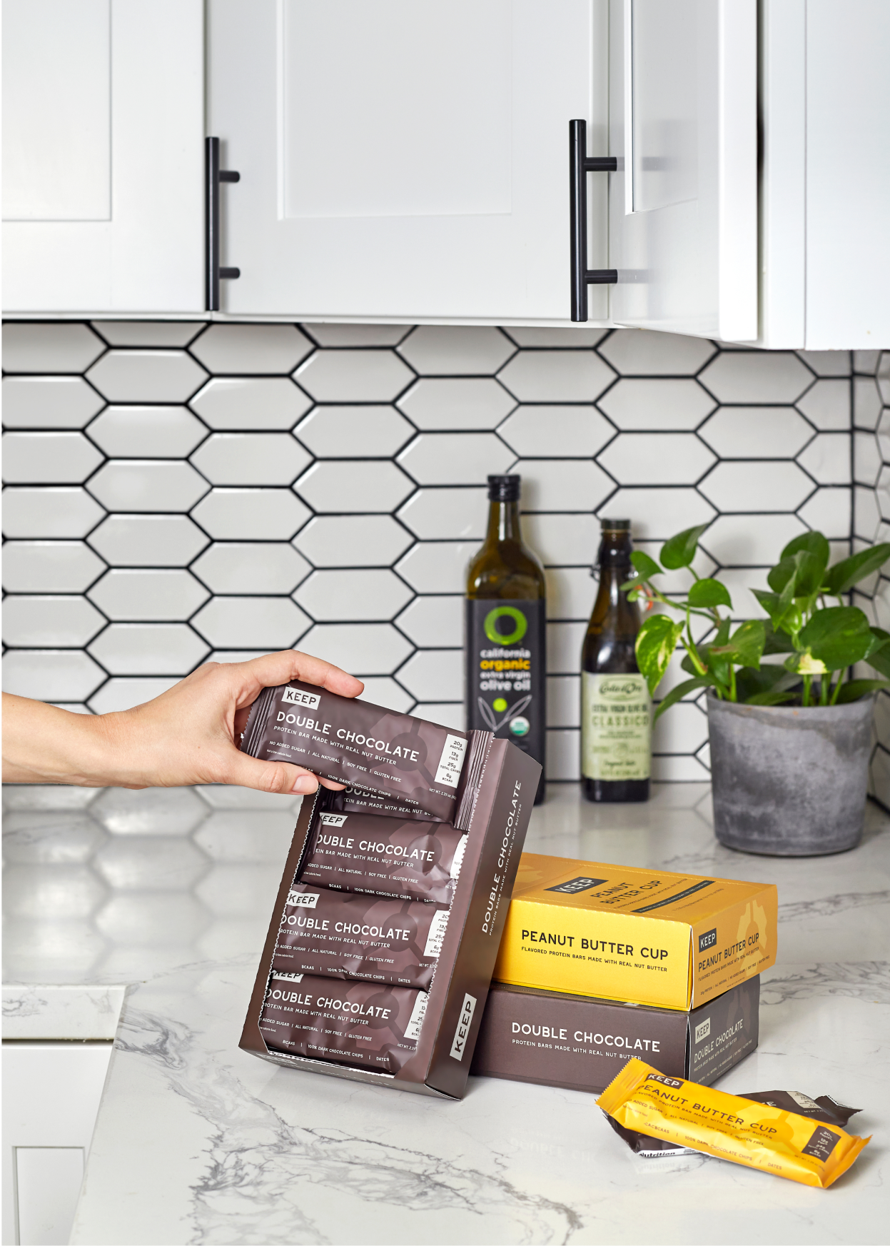 Person taking a double chocolate protein bar from the boxes.